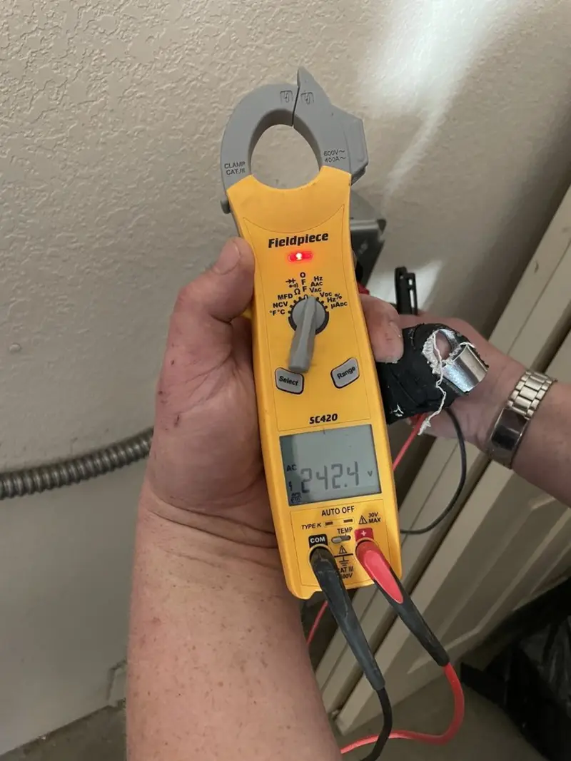 Voltage testing with clamp meter during Outlet Installation in Coe